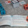 Cards and colorful dice laid out on a table for a game night.