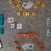Scrabble tiles arranged to spell various words on a carpet.