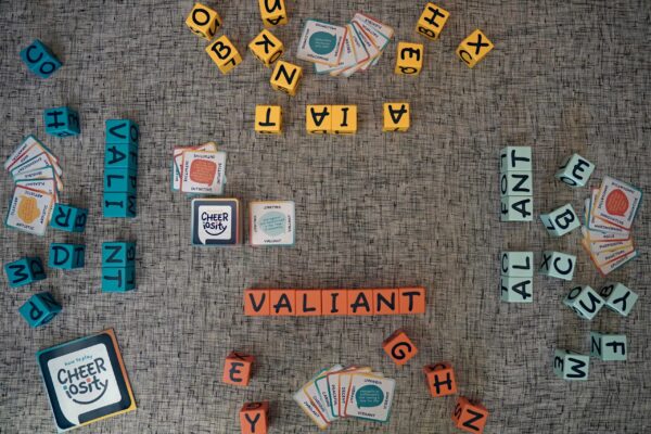 Scrabble tiles arranged to spell various words on a carpet.