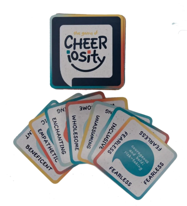 Cheeriosity card game with colorful question cards spread out.